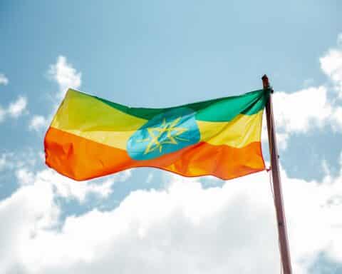 The national flag of Ethiopia, waving on a flagpole.