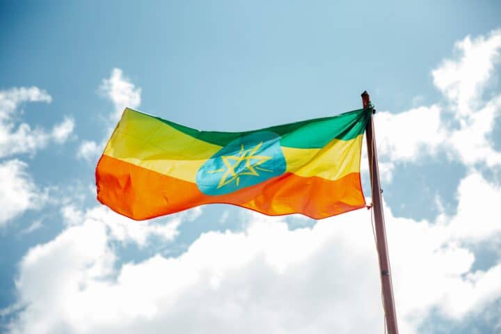 The national flag of Ethiopia, waving on a flagpole.