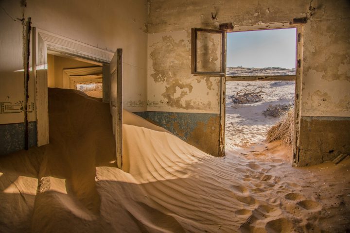 A house overrun by the desert sands.
