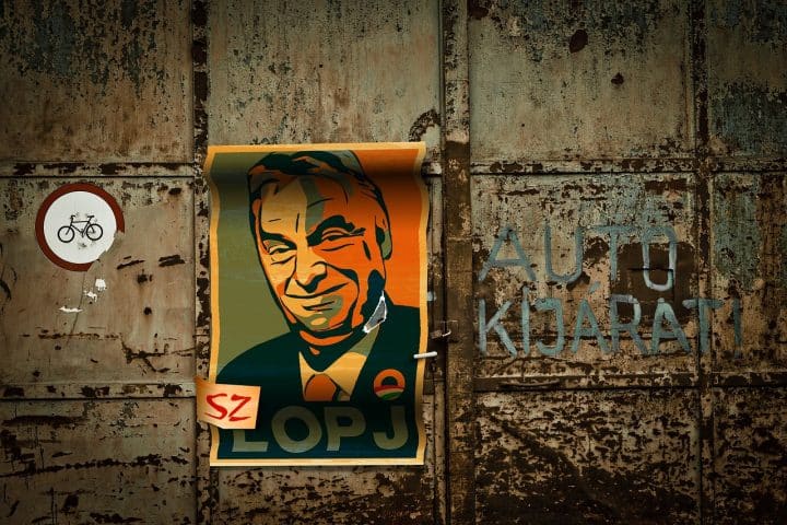 A poster of Viktor Orbán on a rusty garage door.