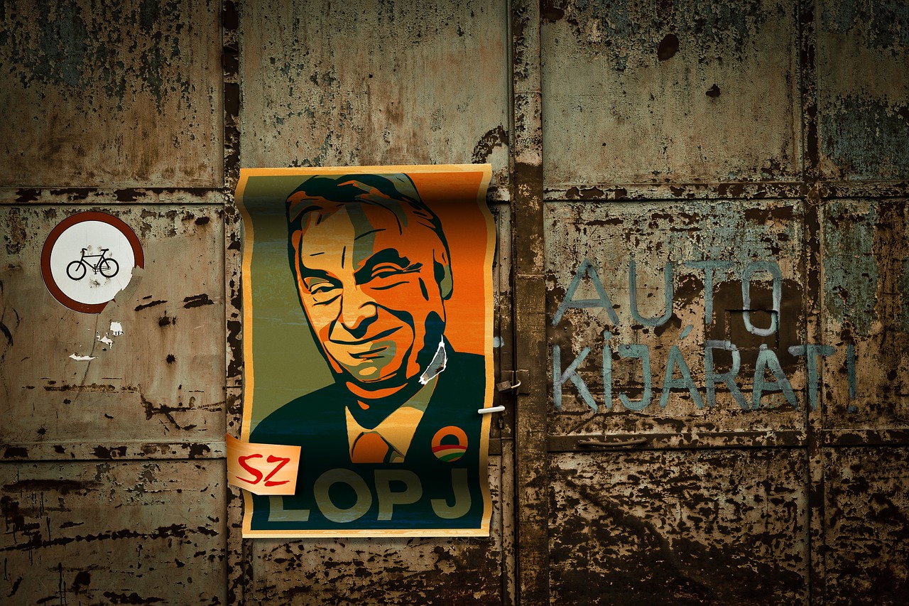 A poster of Viktor Orbán on a rusty garage door.