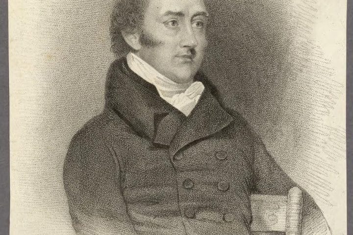 A portrait of George Canning when he was an Member of Parliament. He wears a dark coat with buttons and is sitting in a chair.