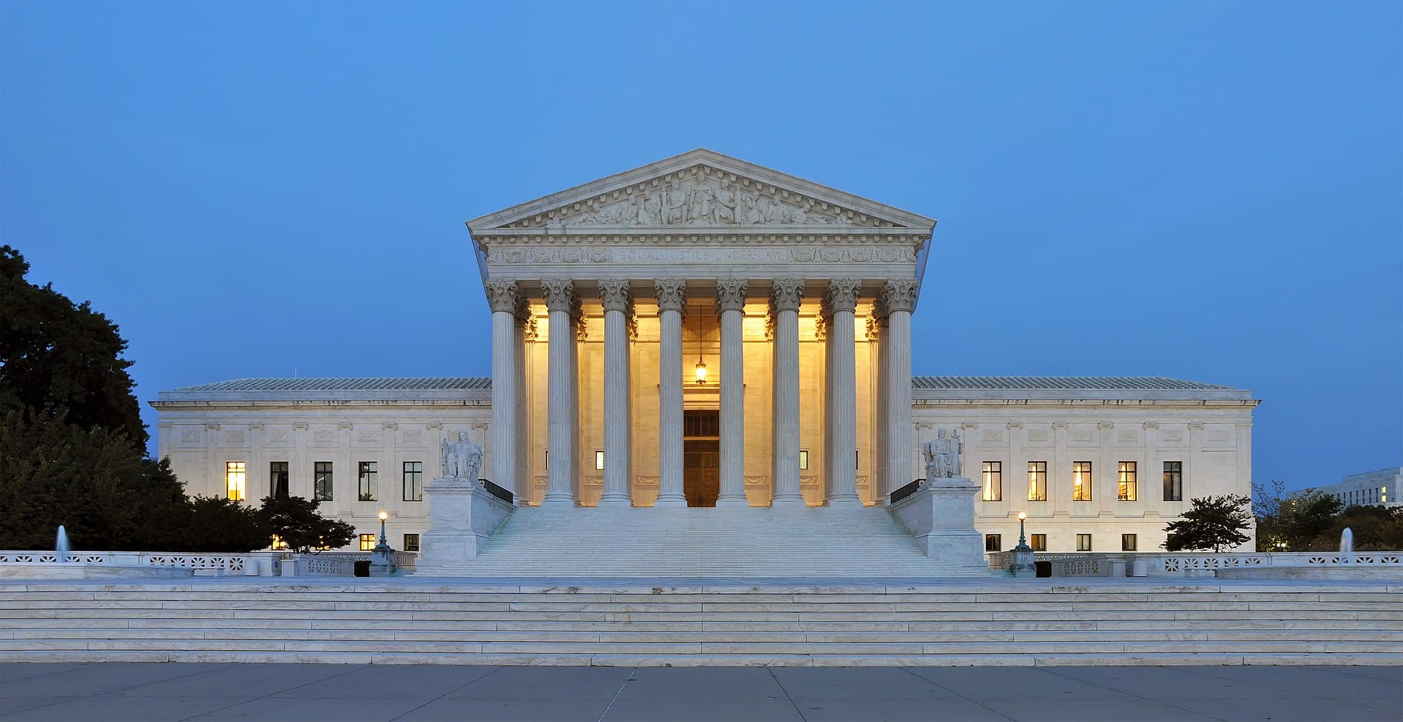 A panorama of the United States Supreme Court Building, in Washington DC. Its perfect geometry and marble pillars showcases its homage to classical Greek architecture.