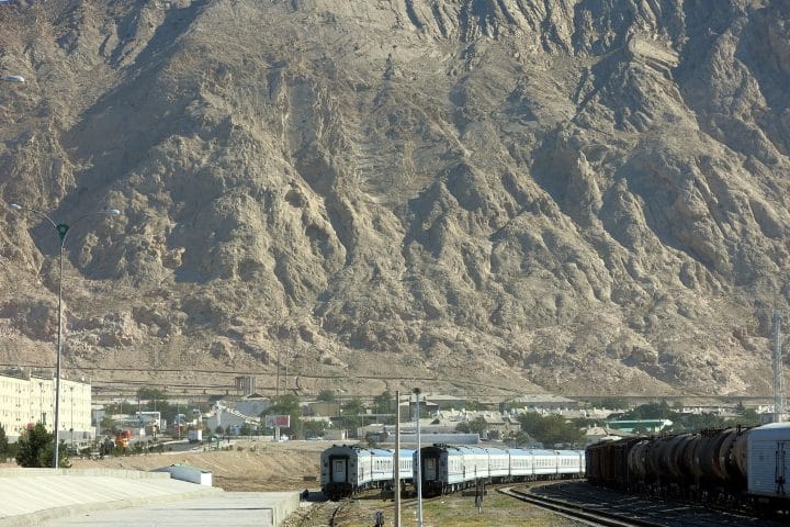 Great arid mountains loom over a town and the Trans-Caspian railway, a key part of the New Silk Road.