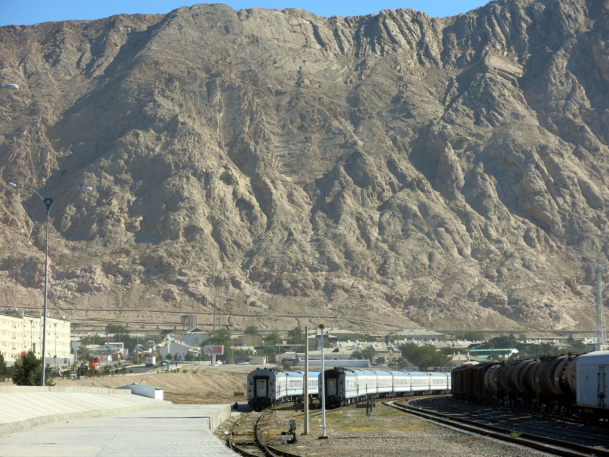 Great arid mountains loom over a town and the Trans-Caspian railway, a key part of the New Silk Road.