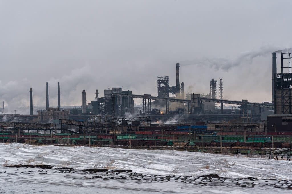 An industrial landscape with trains, chutes and chimneys bellowing smoke in the Karaganda Iron and Steel Plant, Temirtau, Kazakhstan.