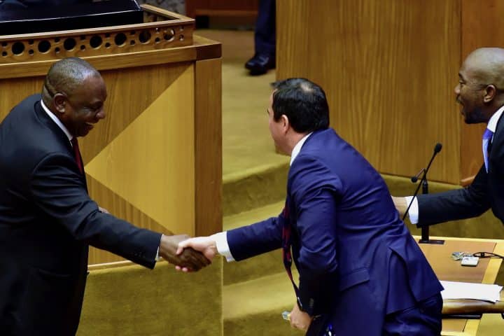South African President Cyril Ramaphosa shaking hands with the leader of the Democratic Alliance, John Steenhuisen.