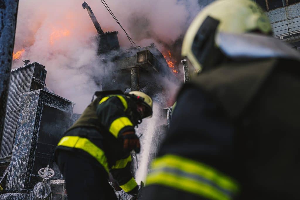 Ukrainian firemen putting out a fire in Kyiv after Russian bombardment.