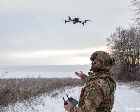 A member of the Ukrainian armed forces flying a drone.