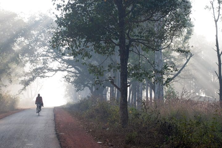 A man on a bicycle.
