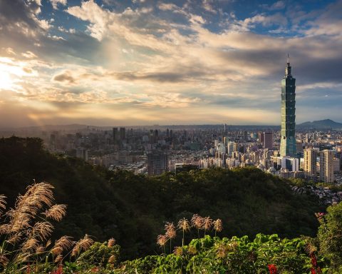 Green hills and skyscrapers in Taipei.
