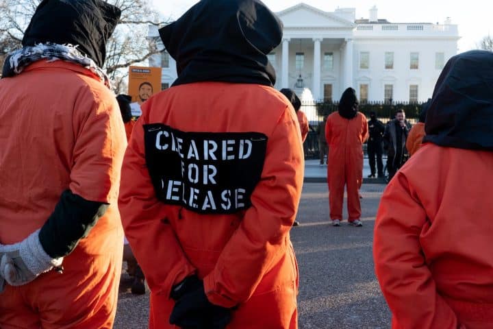Protestors dressed as prisoners from Guantanamo Bay, outside the White House.