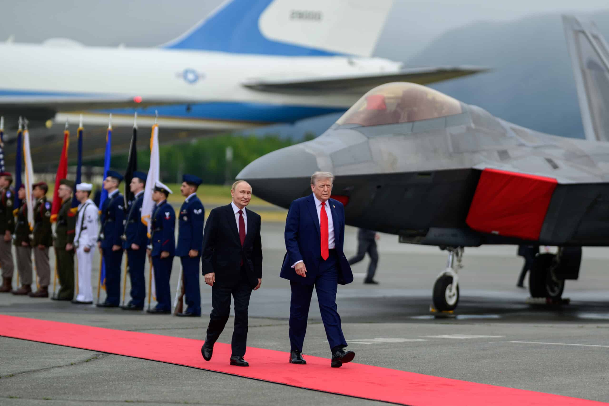 President Trump and President Putin walking down a red carpet from an airplane.
